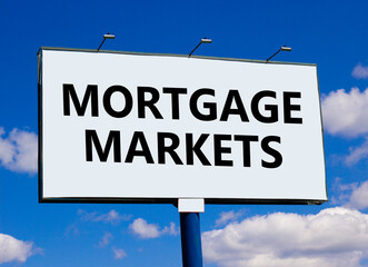 Mortgage markets symbol. Concept words Mortgage markets on beautiful white billboard. Beautiful blue sky white cloud background. Business mortgage markets concept. Copy space.