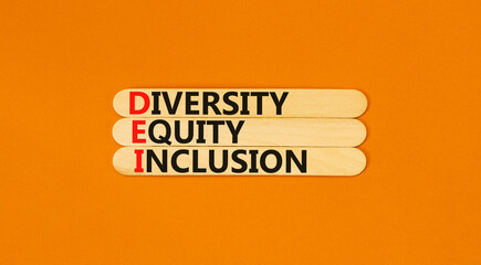 DEI diversity equity and inclusion symbol. Concept words DEI diversity equity inclusion on stick. Beautiful orange background. Business DEI diversity equity and inclusion concept. Copy space.