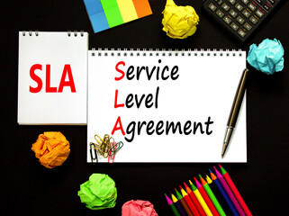 SLA service level agreement symbol. Concept words SLA service level agreement on beautiful white note. Beautiful black background. Business SLA service level agreement concept. Copy space.