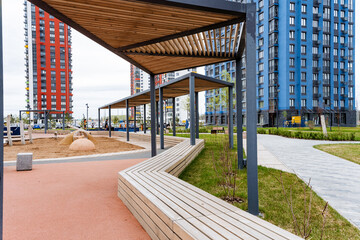 Urban design fixture bench under canopy in front of building