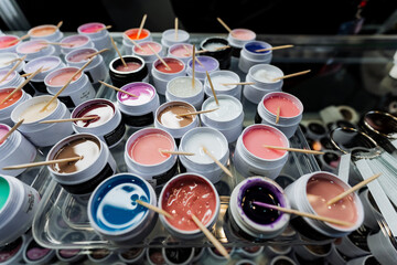 Assorted nail polish products with stirring sticks inside