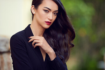 Woman, beauty and makeup with hair care in portrait, confidence and pride with red lipstick, elegance and shine. Glamour, style and cosmetics, assertive and feminine with edgy look and waves outdoor