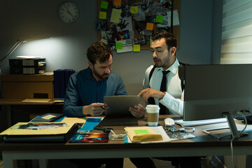 Two professional detectives discussing a case, surrounded by clues and digital tools at night