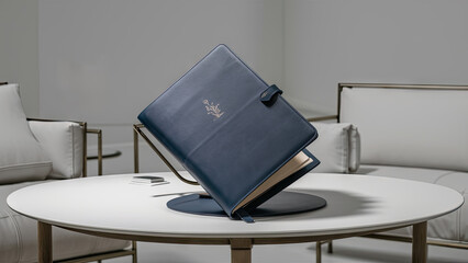  A stunning image of a pristine blue leather folder elegantly positioned on a pristine white desk in a minimalist room.
