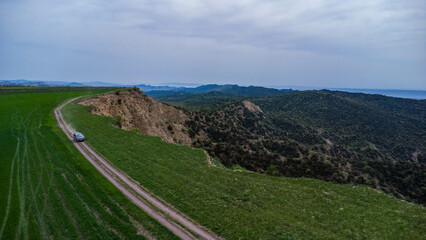 car are move in field near the canyon