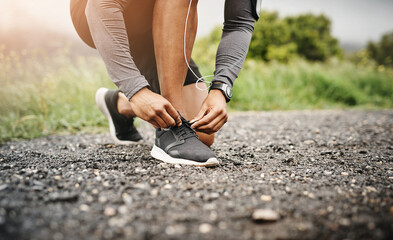 Person, hands and shoelace with fitness or exercise for running, health and wellbeing in outdoor....