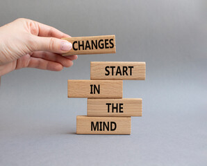 Changes start in the Mind symbol. Wooden blocks with words Changes start in the Mind. Beautiful...