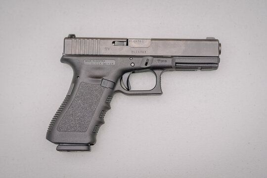Dobele, Latvia - August 18, 2023 - A Glock pistol on a plain background with visible serial number and markings...