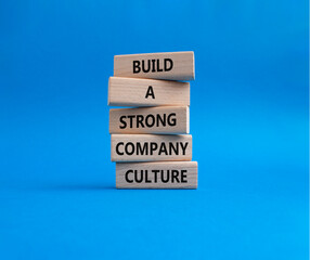 Company culture symbol. Wooden blocks with words Build a strong company culture. Beautiful blue background. Business and Company culture concept. Copy space.