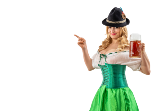 Oktoberfest girl waitress pointing finger at empty copy space. Woman in dirndl, tyrolean hat serving big beer mugs on isolated background. Traditional Bavarian, German, Austrian party, autumn festival