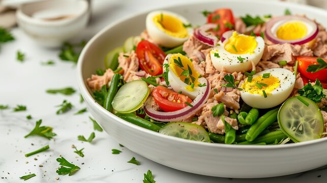 salad with canned tuna, green beans, hard-boiled eggs, red onion, tomato, lettuce
