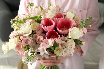Woman with beautiful bouquet of fresh flowers indoors, closeup