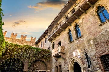 View of Juliet's balcony and house, a Gothic-style 1300s house and museum, with a stone balcony,...