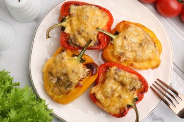 Delicious stuffed peppers served on white marble table, flat lay