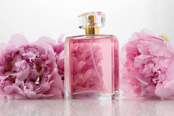 Luxury perfume and floral decor on plastic surface