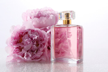 Luxury perfume and floral decor on plastic surface