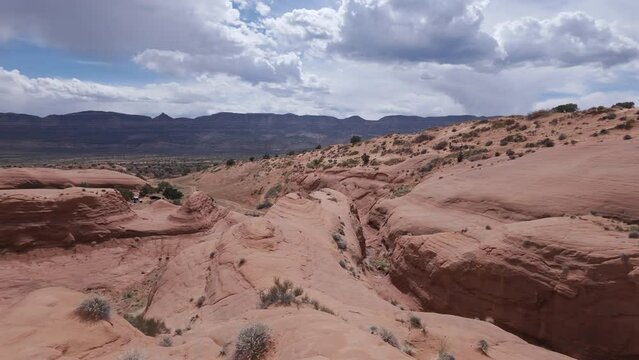 Panning view of the sandstone landscape in the Escalante desert on sunny day in Utah.