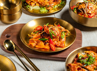 Braised Mackerel Stewed Radish with spoon and chopsticks served in golden dish isolated on wooden board side view of honk kong food