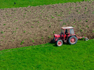 Farmer in tractor preparing land