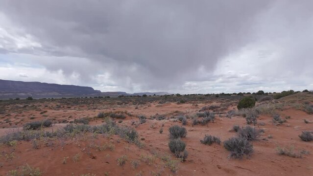 Panning view of rain storm in the Escalante desert looking across the sand.