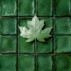 A green leaf on a green cracked tile background.