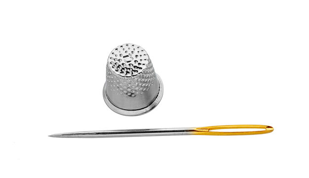 Needle and thimble  on a white