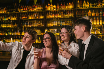Young people happy see each other at party in contemporary restaurant. Men meet attractive brunette...