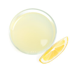 Refreshing lemon juice in glass and slice of fruit isolated on white, top view