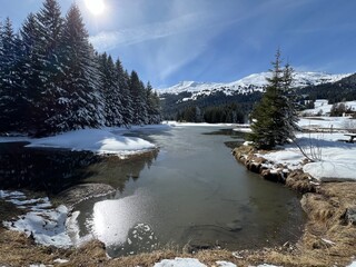 A typical winter idyll on the frozen and snow-covered alpine lake Heidsee (Igl Lai) in the Swiss winter resorts of Valbella and Lenzerheide - Canton of Grisons, Switzerland (Schweiz)