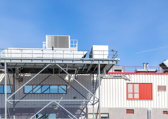 Air handling systems overhanging a two-storey structure, blue sky,, nobody