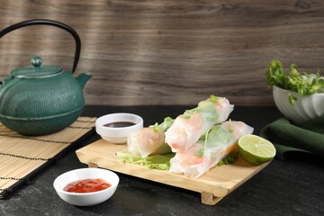Delicious spring rolls served on black table