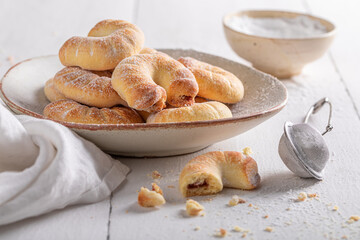 Homemade and sweet croissants with red jam.