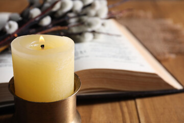 Burning candle on table, closeup. Space for text