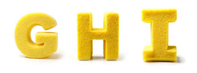 Fototapeta premium Letters G, H, I. Alphabet Made of Yellow Cleaning Sponge on White Background