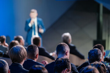 Focused view of a corporate leader speaking to an engaged audience at a professional business...