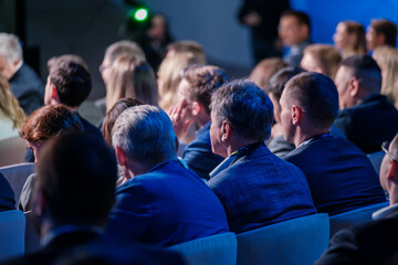 Group of professionals attentively listening during a corporate conference. Focus on engaged...