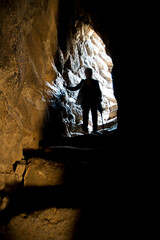 people walking in the tunnel, Woman, silhouette inside the Nuraghe of Santa Sabina. Silanus. Nuoro....