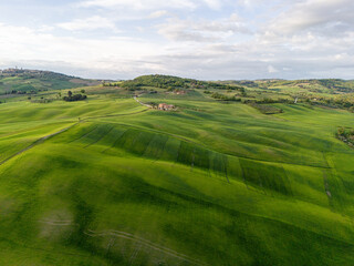 early morning with beautiful sunrise over the Val d'Orcia, countryside in Tuscany. Aerial view.