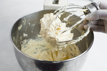  russian buttercream on a whisk, Cream colored american buttercream on a whisk attachment - obrazy, fototapety, plakaty
