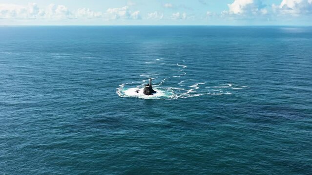A lighthouse rising out of the ocean. Fastnet lighthouse 4k