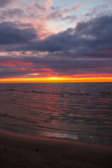Sunset on the Baltic Sea. Purple clouds and red horizon