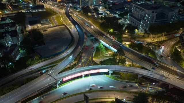night time illumination flight over kuala lumpur city traffic interchange road aerial topdown panorama 4k timelapse malaysia