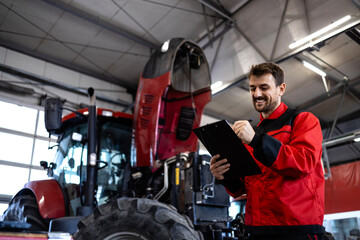 Professional serviceman standing by the tractor machine and holding checklist.