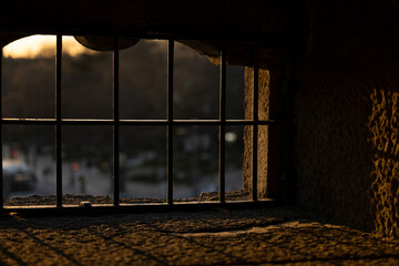 Silhouette of a window grid in an old castle at sunset.