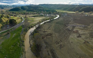 Land covered in silt from the overflowing eskdale river from the Cyclone Gabrielle natural disaster. A clean up crew is clearing the damage. Pohokura-Bay View, Napier, 