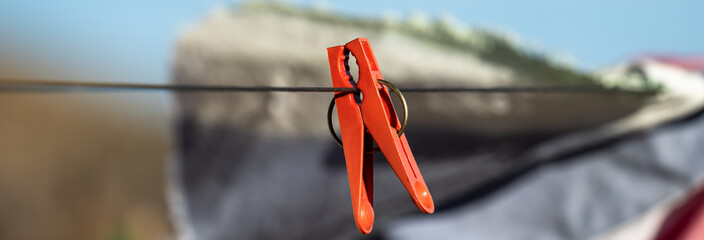 Red clothespin on a rope, stock image