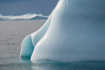 very large base of iceberg foreground with smaller icebergs background in the ocean, Ilulissat...