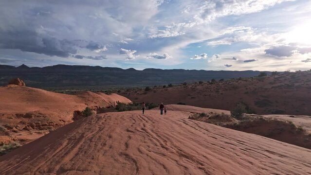 Walking over sandstone in the Escalante desert moving over the landscape in scenic view.