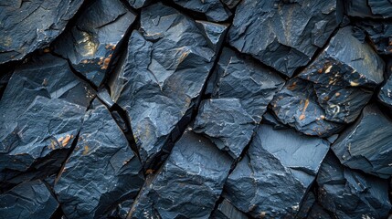 A close up of a rock wall with a blue and black color scheme. The image has a moody and mysterious feel to it, as the rocks are jagged and rough, giving the impression of a rugged