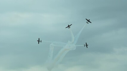 Pilots perform aerobatic stunts in the sky, executing dizzying maneuvers